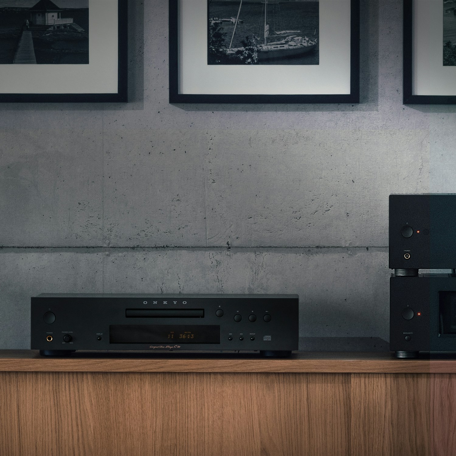 Onkyo C 30 CD Player closeup on wood cabinet beside small bonsai tree 2000x2000